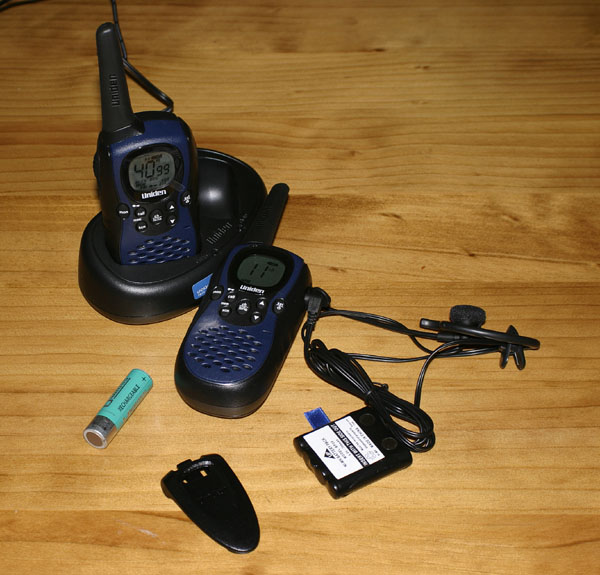 The Kit, 2 radios, desk charger, batt, mic and AA batt for size reference