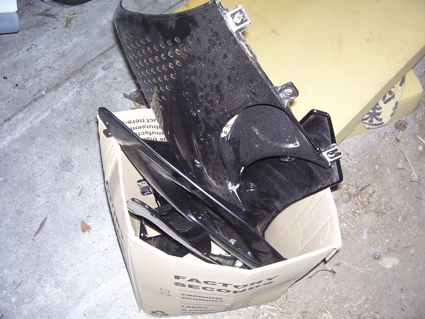 Box of bits that they gave me at the towyard and said were with the bike. They're not 7R fairing though!