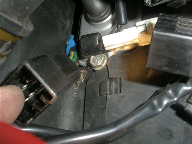 The rubber must have been torn when the mechanic pushed the wiring up where it wasn't meant to go.