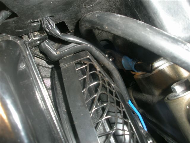 Plastic guard has been forced up and wire pushed up underneath (blue tape)